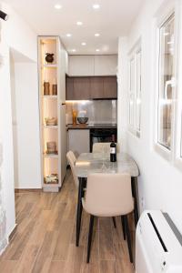 a kitchen with a table and chairs in a room at Apartments Kostic- Sea view in Tivat +46 photos