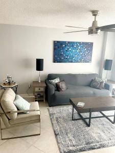 a living room with a couch and a table at Quiet direct oceanfront 2 bed 2 bath condo w/pool in Ormond-by-the-Sea