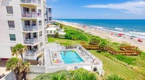 an aerial view of a building and the beach at Quiet direct oceanfront 2 bed 2 bath condo w/pool in Ormond Beach