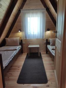 a room with two beds and a window at Holiday chalet Asterix in Žabljak