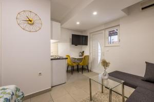 a living room with a couch and a table at Studio Apartment Nikol in Split +10 photos
