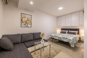 a living room with a couch and a bed at Studio Apartment Nikol in Split