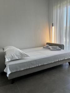 a bed sitting in a room with a window at Jason Holidays Skala Rachoniou in Skala Rachoniou +38 photos