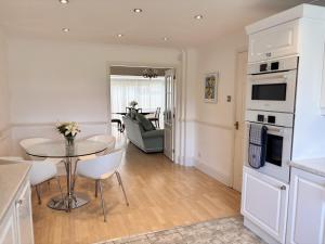 a kitchen and living room with a table and chairs at Spacious Home for Workers & Families - Quiet area in Newton Aycliffe