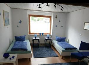 a living room with two beds and a window at Ferienwohnung Obhausen bei Querfurt in Obhausen