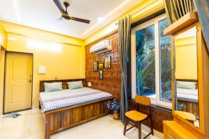 a bedroom with a bed and a window at Riverside Retreat in Kalyānpur