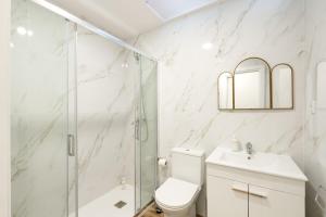 a bathroom with a shower and a toilet and a sink at VIVA Spacious Apartment Campanhã in Porto +20 photos