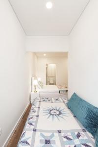 a bedroom with two beds and a rug on the floor at VIVA Spacious Apartment Campanhã in Porto