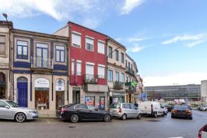 a city street with cars parked in front of buildings at VIVA Spacious Apartment Campanhã in Porto