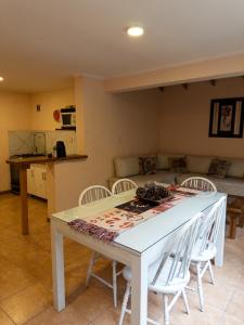 a kitchen and living room with a table and chairs at Casa Llao alojamiento de montaña in San Carlos de Bariloche