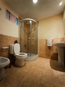a bathroom with a shower and a toilet and a sink at Casa Llao alojamiento de montaña in San Carlos de Bariloche +32 photos