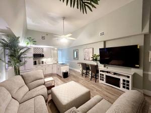 Una sala de estar con dos sofás y un televisor de pantalla plana. en First floor direct beach access, en Daytona Beach