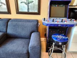 a living room with a blue couch and a game console at Daytona Beach 1 bdrm Oceanfront Luxury Condo in Daytona Beach +44 photos