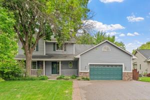 a gray house with a green garage at Ultimate Family Fun Escape in Champlin