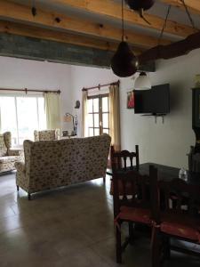 a living room with a couch and a table at Villa Serena Deportista in Necochea