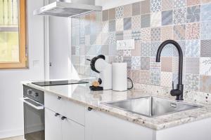 a kitchen with a sink and a counter top at Marismas - by Wehomes - casa in Pontejos +80 photos