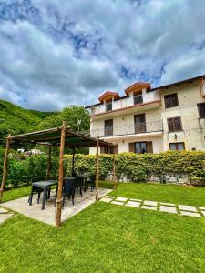 a building with a table and chairs in a yard at La Villa Carmelina in Agerola +22 photos