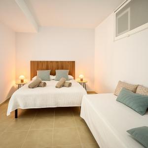 a bedroom with two beds and two tables at Beach and Golf Holiday Home with private jacuzzi in Maspalomas +55 photos