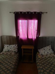 Giường trong phòng chung tại Résidence mouna +1 ảnh