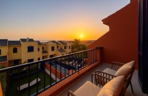 a balcony with a view of the sunset at Beach and Golf Holiday Home with private jacuzzi in Maspalomas