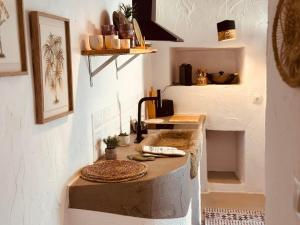 a kitchen with a table in a room with a fireplace at Refúgio do Duque in Motrinos