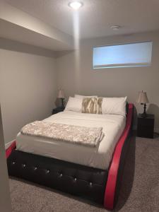 a bedroom with a large bed with a black frame at Elegant Cozy Private Apartment in Calgary