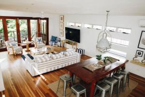 a living room with a couch and a table at Family Beach House at Twin Waters Resort in Twin Waters