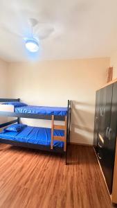a room with two bunk beds and a refrigerator at Refúgio do Aconchego Frente Praia Ocean Club in Mongaguá +30 photos