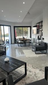 a living room with a table and chairs in it at Villa de Campagne in Es Somaa