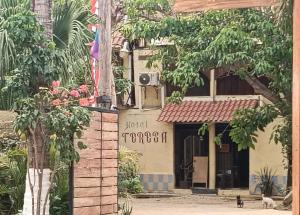 a building with a sign on the side of it at Hotel Hostal Teresa in Zipolite