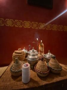 a table with a group of dishes and candles on it at Villa ayyur in Souira Guedima +14 photos