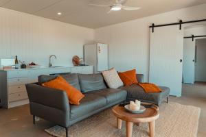 a living room with a couch and a table at Glenayr Farm in Windeyer