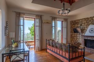 a living room with a table and a fireplace at Hillside View, House 1 in Stoupa