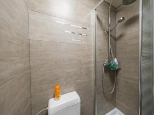 bagno con doccia e servizi igienici bianchi di Cozy Stay by the Sea, cleaning included a Westende