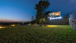 a building with a sign on it at night at Gyeongju Forest 258 Pet-friendly Pool Villa in Gyeongju +8 photos