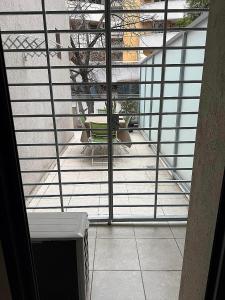 a balcony with a view of a table and a bench at Nueva Córdoba Ejecutivo in Cordoba