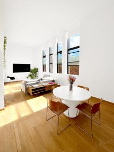 a living room with a white table and chairs at Sunny & Spacious Duplex in Lower East Side in New York +4 photos