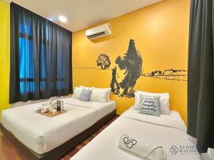 two beds in a room with yellow walls at Holi 1Medini Themed Suites in Nusajaya +181 photos