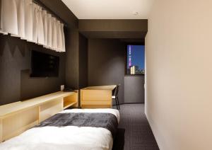 a hotel room with a bed and a window at FL Hotel Asakusa in Tokyo
