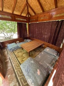 a room with two beds and a wooden table at Lovely home shatry in Osh