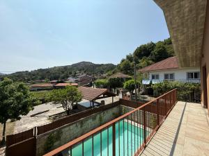 a view from the balcony of a house with a swimming pool at Casa da Fonte - Gerês in Terras de Bouro