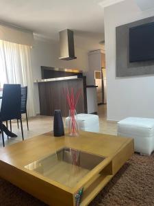 a living room with a couch and a table at Apartamento moderno y economico in Mérida +4 photos