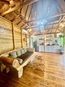 a living room with a couch in the middle of a room at Joglo Valley Villa by Rare Angon Ubud in Ubud