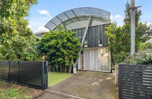a house with a metal gate in front of it at Stunning Architectural Home in Brisbane