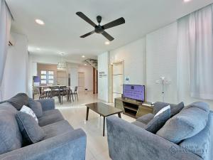 a living room with a couch and a ceiling fan at Holi 1Medini Themed Suites in Nusajaya