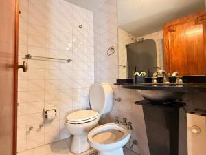 a bathroom with a toilet and a sink at Decimo in Villa Mercedes