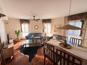 a living room with a table and a dining room at Decimo in Villa Mercedes