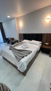 a bedroom with a large bed in a room at 2 минуты до моря in Batumi +81 photos