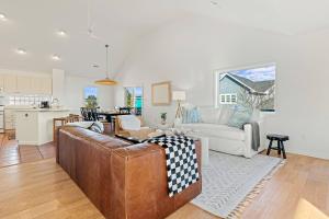 a living room with a couch and a kitchen at 2 Min Walk to Beach -Ocean View-Heated Pool-Modern in Poplar Branch