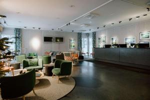 a large room with a lobby with green chairs at Ice Hotel in Jukkasjärvi +37 photos
